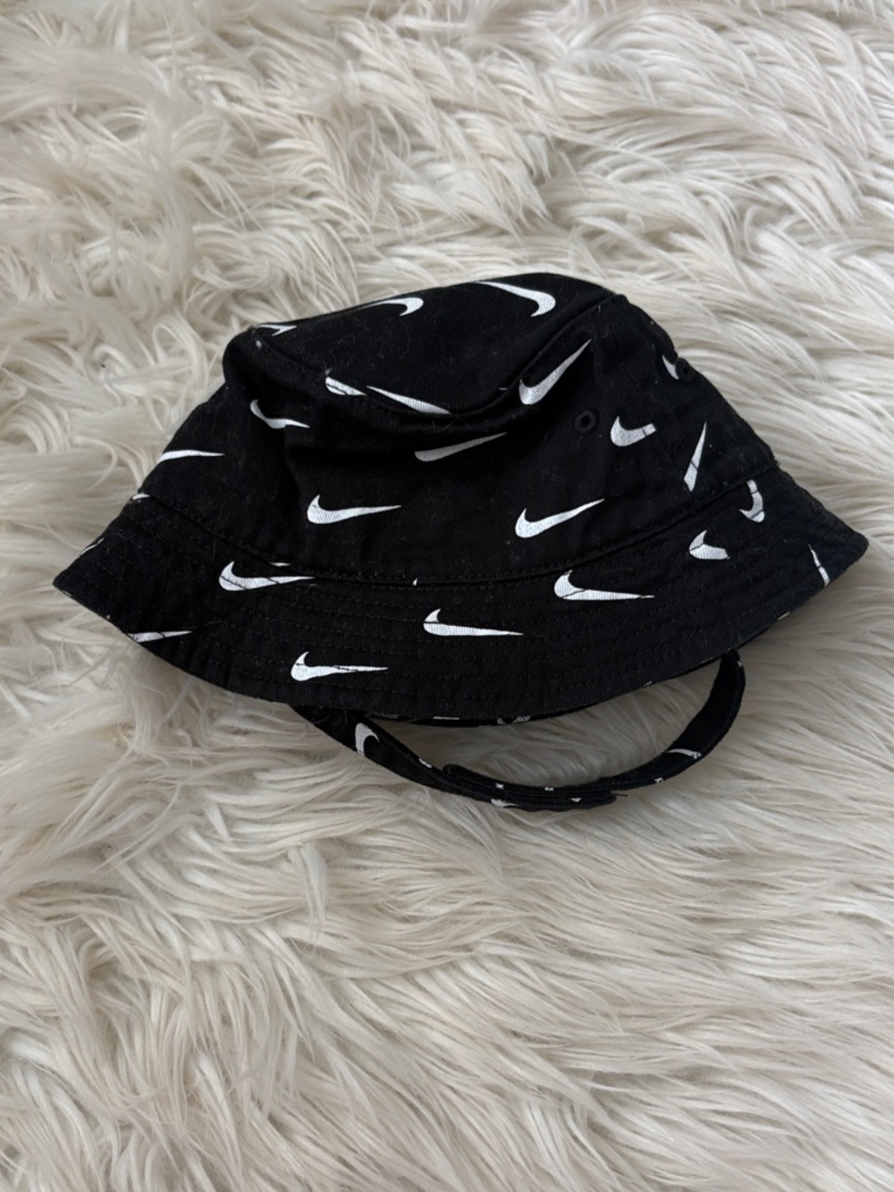 Nike Black Bucket Hat with White Swoosh Pattern - infant